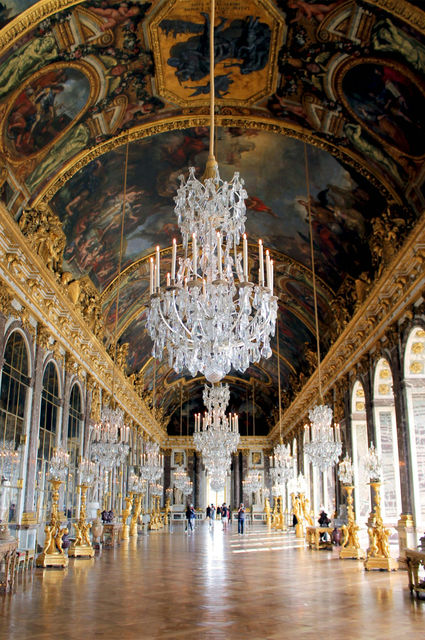 a chandelier hanging from the ceiling of a palace