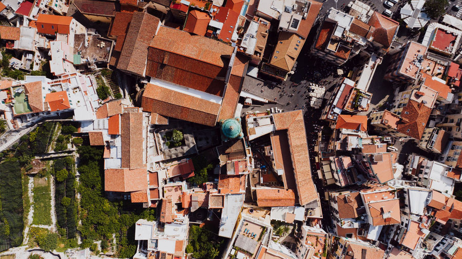 Stunning aerial shot of Amalfi, Italy showcasing the town's iconic red tiled roofs during daytime.