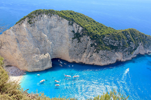 Stunning aerial view of Navagio Beach, Zakynthos, with turquoise waters and dramatic cliffs.