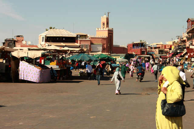 A group of people walking around a market