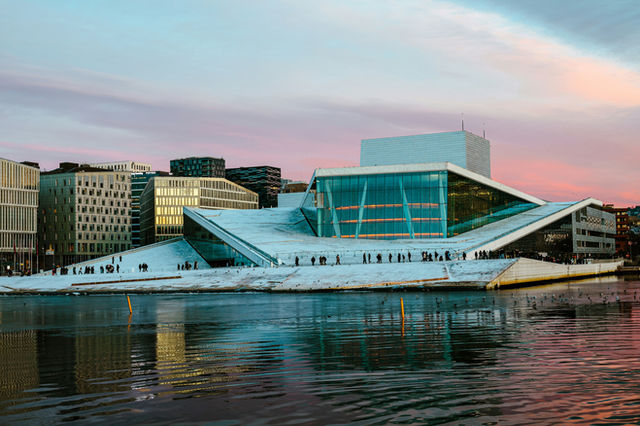 Modern white building with glass facade by the water