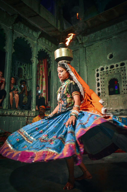 A dancer turns, ghoomar skirt flaring