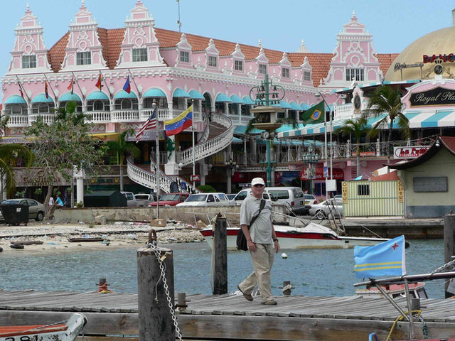 Waterfront wharf in downtown Oranjestad with the pink Dutch-colonial Royal Plaza Mall behind