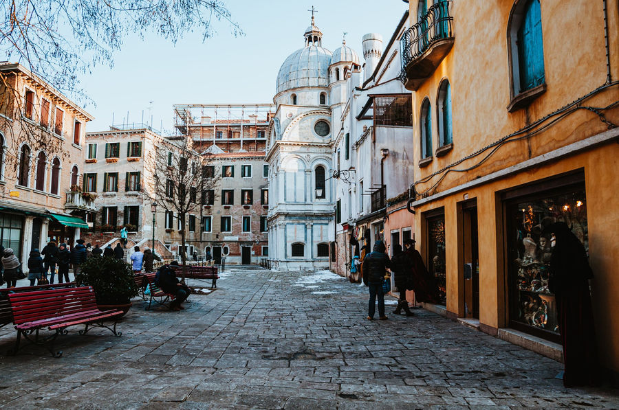 A picturesque cobblestone street in Venice, showcasing historic architecture and charming shops.