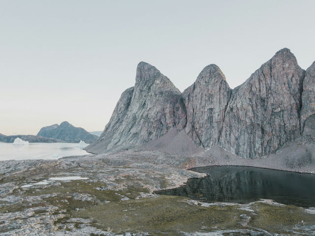 a mountain range with a lake in the foreground