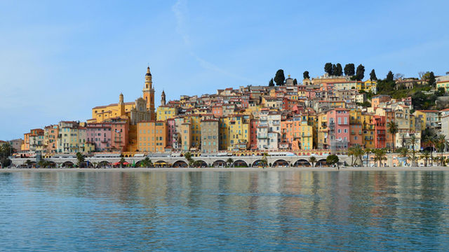 Vibrant townscape of Menton with colorful buildings along the sparkling coast of the French Riviera.