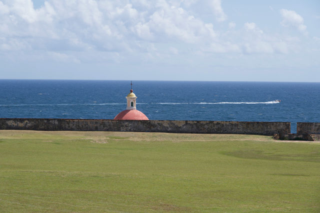 a view of the ocean and a boat in the distance