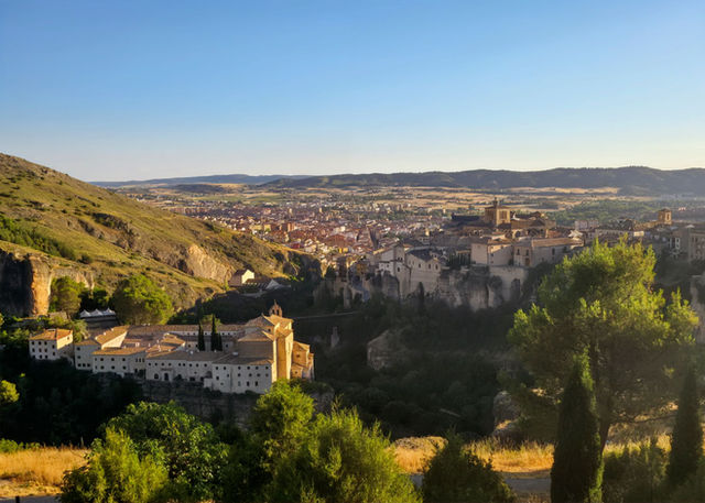 Captivating sunset view of Cuenca, Spain, showcasing historic architecture and natural beauty.