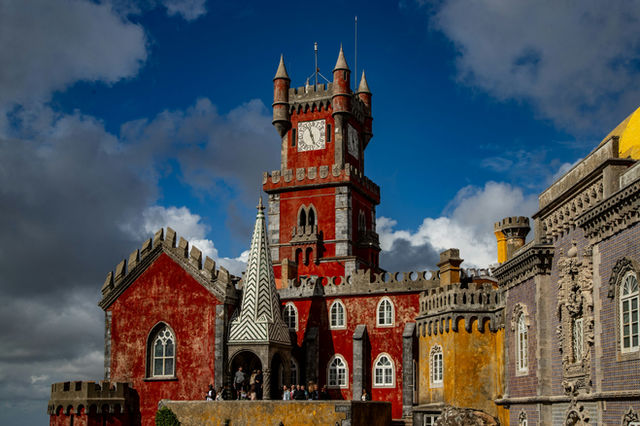 Colorful pena palace with a prominent red clock tower.