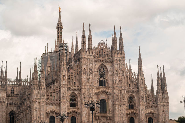 Beautiful shot of Milan's iconic Gothic cathedral under a cloudy sky.