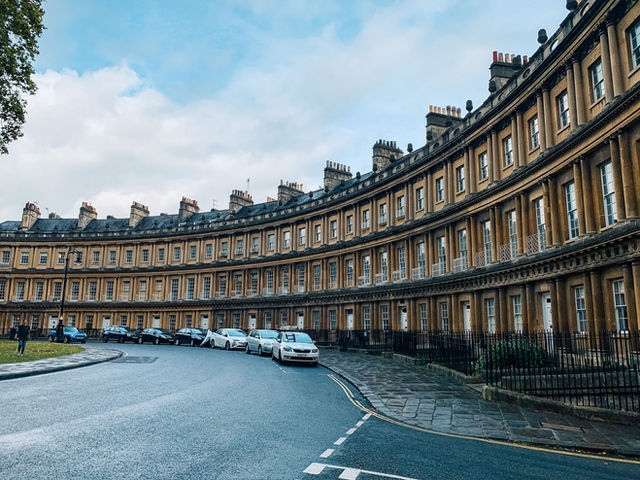The iconic curved facade of the Royal Crescent in Bath, showcasing Georgian architecture.