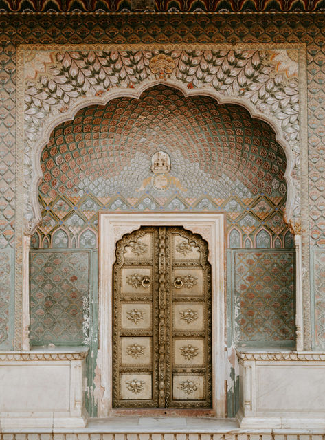 A carved doorway in pale stucco
