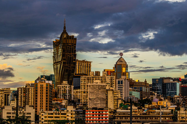 a view of a city with tall buildings under a cloudy sky