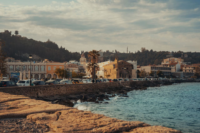 A beautiful coastal view of Zakynthos, Greece, featuring historic architecture and a seaside promenade.