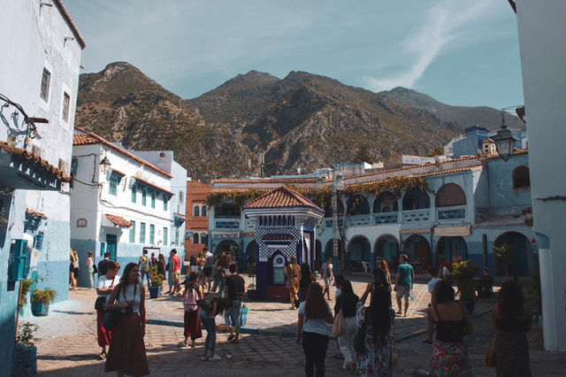 Explore the vibrant streets and rich culture of Chefchaouen, Morocco, with stunning mountain backdrops.