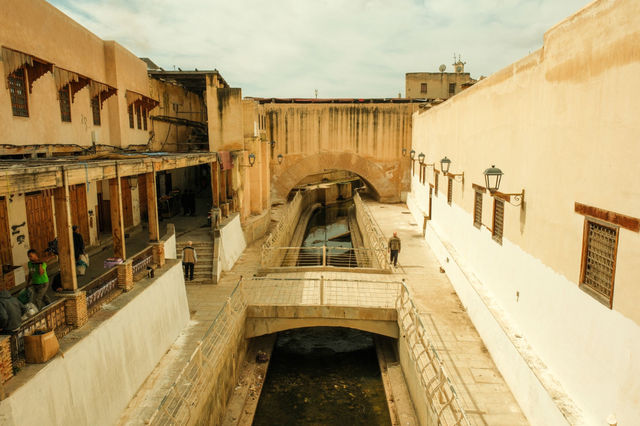 Explore the historic passageway in Fes Medina, showcasing traditional Moroccan architecture.