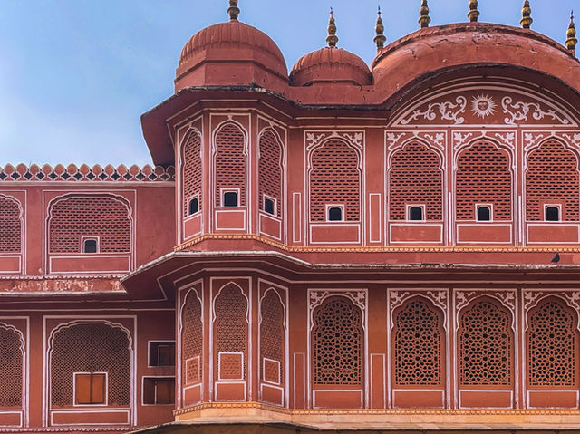 Captivating intricate architectural details of Hawa Mahal, Jaipur in vibrant pink hues.