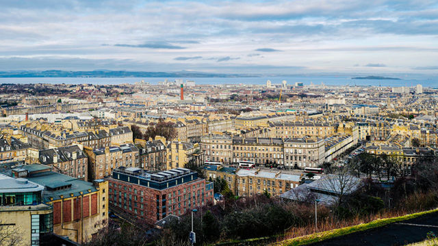 Scenic aerial view over Edinburgh's New Town, showcasing classic architecture and the North Sea.