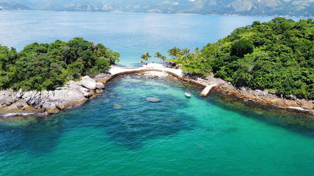 Stunning aerial view of a tropical island in Angra dos Reis, Brazil, surrounded by turquoise ocean water.