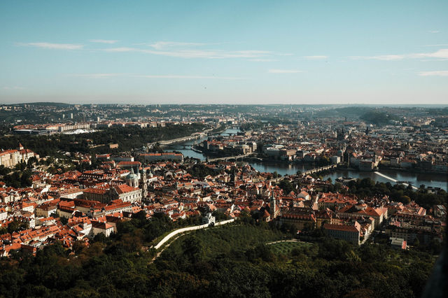 Stunning aerial vista of Prague showcasing the iconic Charles Bridge and Vltava River in the heart of the city.