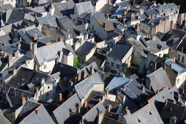 Charming aerial view of Chinon's traditional rooftop architecture in France, highlighting historic urban scenery.