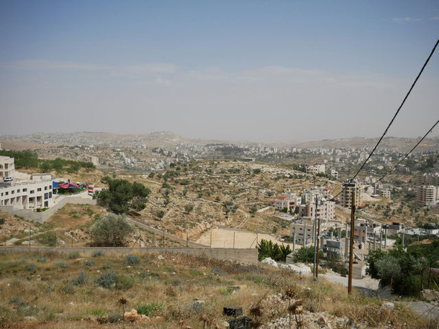 a view of a city from the top of a hill
