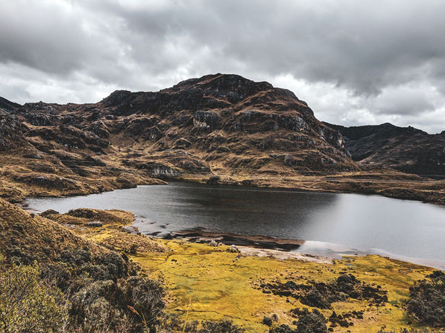 Dramatic mountain landscape with a tranquil lake in Cajas National Park, Ecuador.