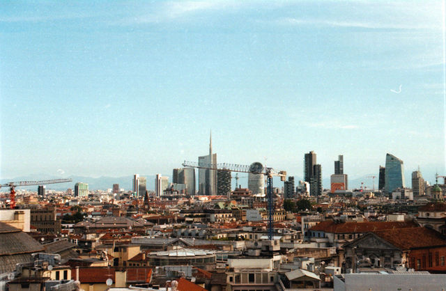 Expansive view of Milan's modern skyline under a clear blue sky.