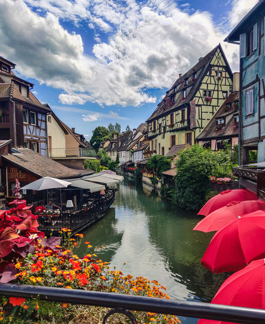 red umbrella on river near houses