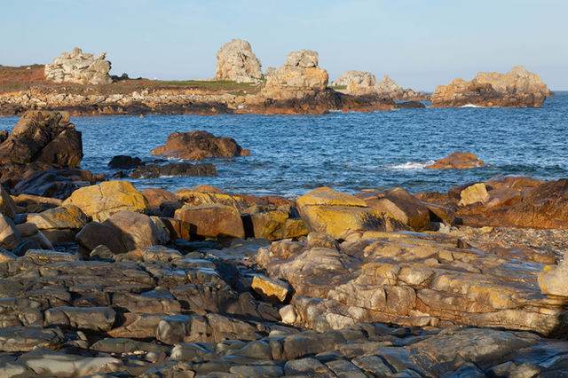 Explore the rugged rocky coastline of Plougrescant, capturing the serene beauty of Brittany's seashore.