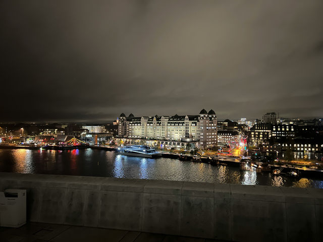 A serene reflection of Norway's vibrant culture, captured in the majestic Oslo Opera House, where art and architecture harmonize with the tranquil waters of the fjord.