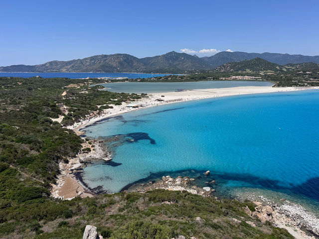 Stunning aerial view of Sardinia's coastline with turquoise waters and Mediterranean landscape.