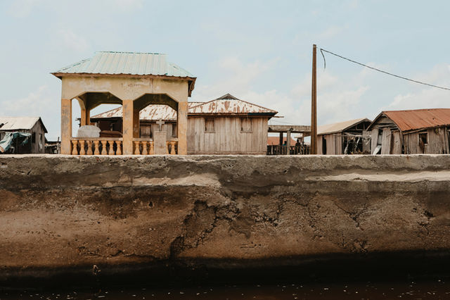 Houses sit along a cement structure.