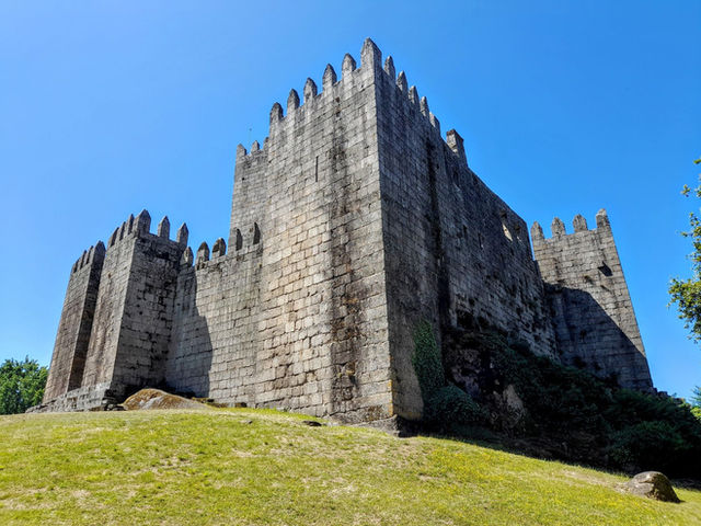 Explore the historic medieval castle in Guimarães, Portugal, with its striking architecture.