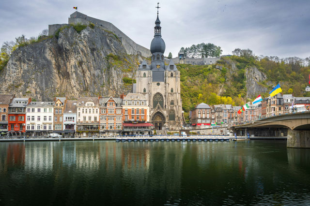 Town with church and castle on a rocky cliff.