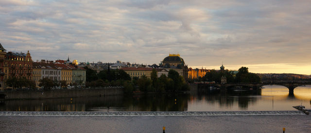 Cityscape with river and bridge at sunset