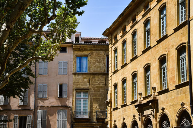 Beautiful historical buildings in Aix-en-Provence, showcasing traditional French architecture under a clear sky.