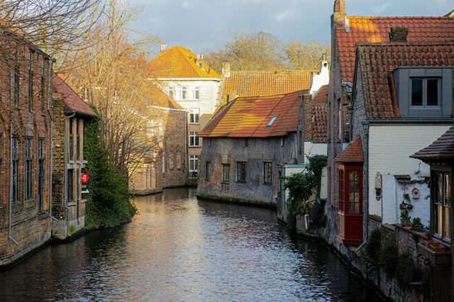 A river running through a city next to tall buildings