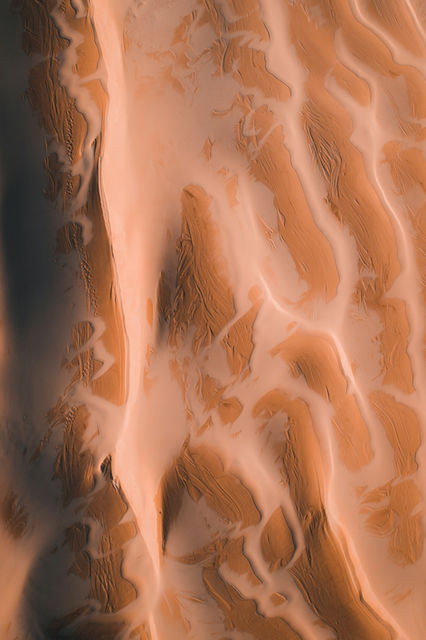 a close up of a sand dune with a sky background