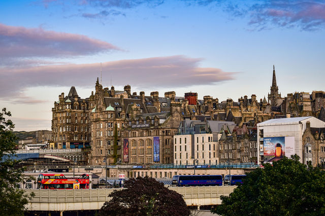 A beautiful view of Edinburgh's historic skyline at sunset, capturing City Art Centre and old buildings.