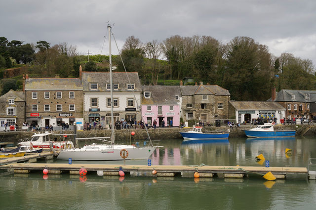 Picturesque view of Padstow Harbour with fishing boats and historic buildings in Cornwall, UK.