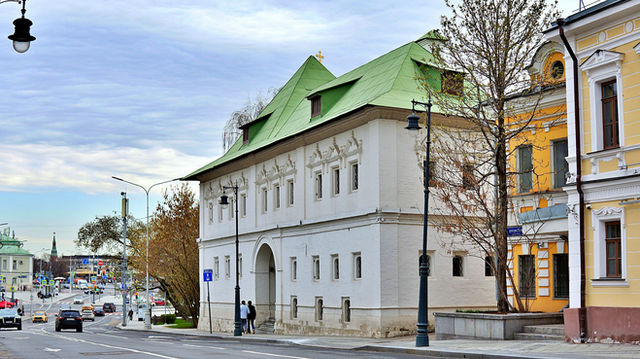 Historic white building with green roof and arched entrance