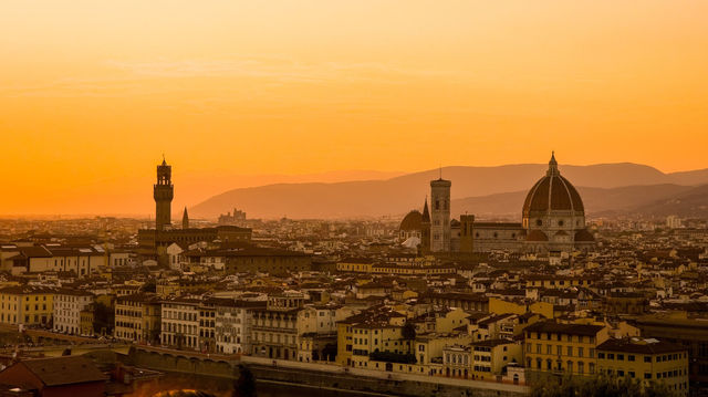 Breathtaking view of Florence cityscape with iconic Duomo and Palazzo Vecchio at sunset.