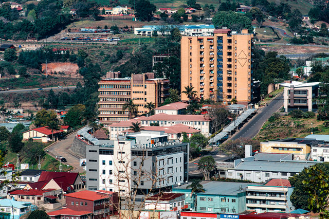 City buildings nestled amongst green hills.