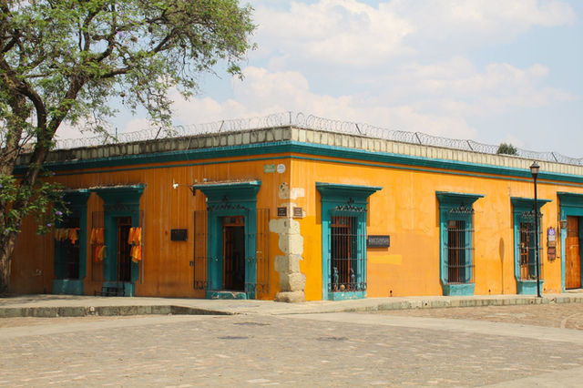A colorful colonial-style building in Oaxaca City, showcasing traditional Mexican architecture.