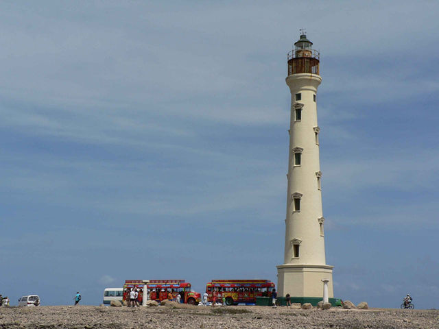 The white California Lighthouse standing on the rugged scrubland of Aruba's northwest tip