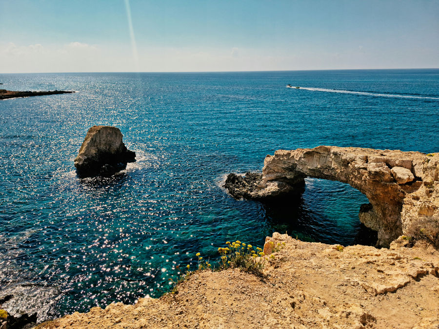 a body of water with a bridge and a boat in the distance
