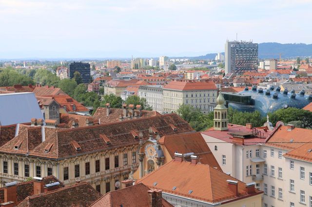 Stunning aerial view of Graz, Austria showcasing the city's iconic red rooftops and unique architecture.