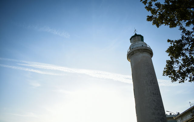 A tall lighthouse against a clear blue sky.