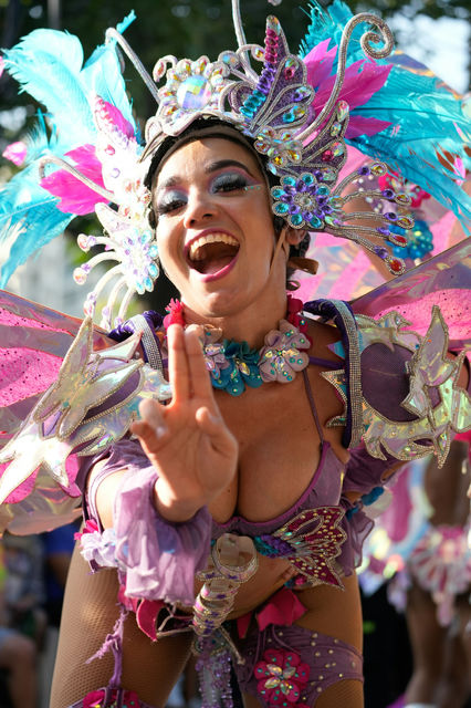 Mid-laugh in butterfly wings — the Carnaval de Barranquilla